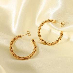 18K gold plated stainless steel C-shaped twisted earrings on light gold silk fabric