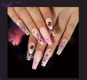 Close-up of pink Halloween press-on nails with spider web, heart and pumpkin detail