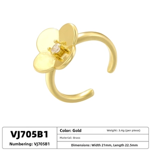 Detailed view of gold flower ring with pearl inlay and brass texture specifications