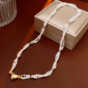 Detail of double-layer pearl necklace with silver blocks and gold heart magnetic clasp