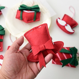 Miniature red and green felt Christmas tree ornaments with festive hanging ropes