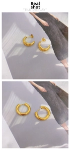 Detail view of 18K gold-plated textured croissant stud and smooth round hoop earrings