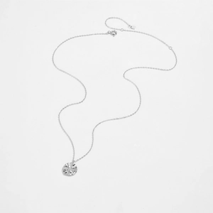 Macro detail of S925 sterling silver necklace showing intricate round cross flower pendant