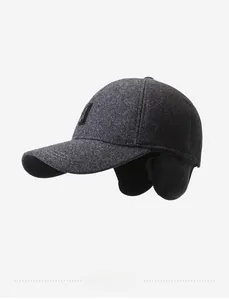 Detail of dark grey wool winter baseball cap with ear protection flaps and logo
