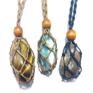 Detailed view of hand-woven cord net pendants with tiger eye and labradorite stones