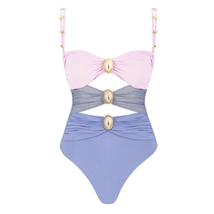 Detail of cutout color block one-piece swimsuit with metallic buckles and pink accents