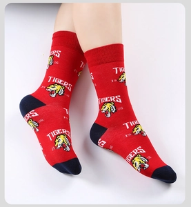 Detail of red crew sock featuring white TIGERS lettering and embroidered tiger head patch