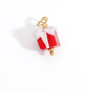 Detail shot of a red Christmas gift box charm with gold metal loop for DIY necklaces