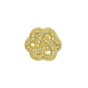 Detailed close-up of 18k gold plated crisscross ring with pavé zircon stones on white background