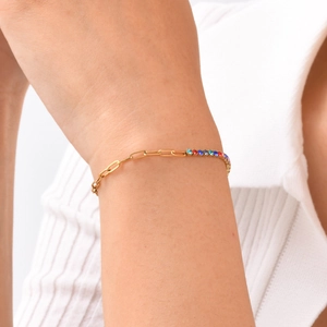 Golden stainless steel chain bracelet with colorful zircons worn on model's wrist