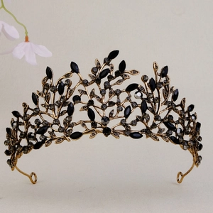 Detail of vintage gold alloy crown featuring intricate black rhinestones and leaf textures