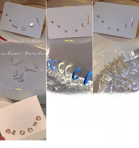 Detail view of assorted geometric stud earrings and faux pearl hoops in gold and silver