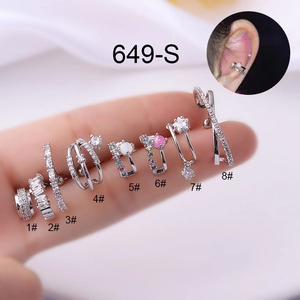 Detail showing eight silver stainless steel cartilage earrings with gemstones and crystals