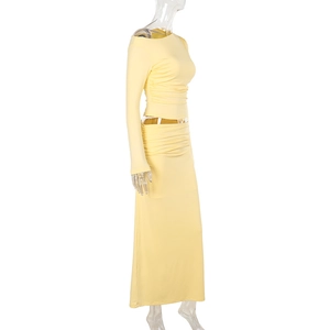 Detail view of the light yellow slim fit off-shoulder long sleeve top and long skirt set