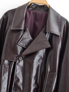Detail of dark brown faux leather trench coat collar and double-breasted buttons