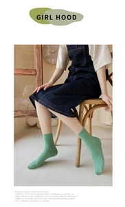 Detail of light green ribbed combed cotton socks on model for casual styling