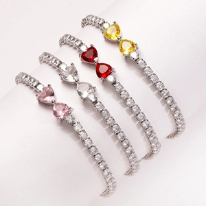 Detail view of colorful zircon tennis bracelets with double heart shaped stones