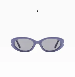 Detail view of purple oval sunglasses with glossy frames and silver dot accents