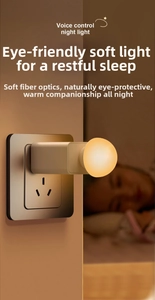 Close-up of a voice-controlled LED night light plugged into a wall socket for eye protection
