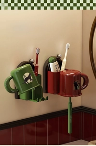 Detail of suction cup wall-mounted toothbrush holders with animal print cups and slots