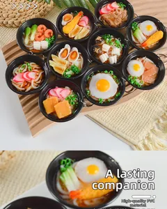 Detailed macro view of realistic PVC mini udon noodle bowl with egg and tempura toppings