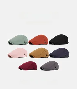 Detail view of colorful men's newsboy caps with adjustable metal buckles in various colors