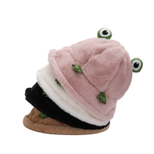 Stack of plush cartoon frog bucket hats in pink, white, black and brown colors