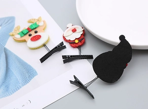 Détail des pinces à cheveux de Noël à paillettes avec renne, Père Noël et ressorts