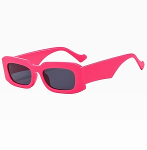 Detail of wide wavy temples on hot pink rectangular sunglasses with dark lenses
