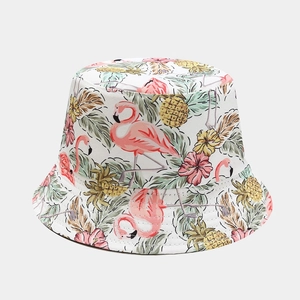 Detail of flamingo and tropical plant print on a white foldable cotton sun bucket hat