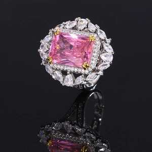 Elegant fashion ring featuring a pink rectangular gemstone with diamond accents and a silver finish