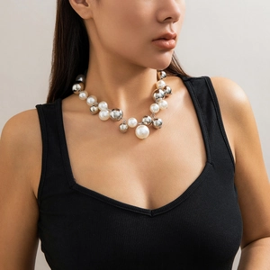 Close-up of oversized white pearls and mirrored silver metal beads on a choker necklace