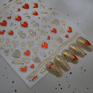3D heart nail art stickers with gold embossed edges and red and silver gem patterns