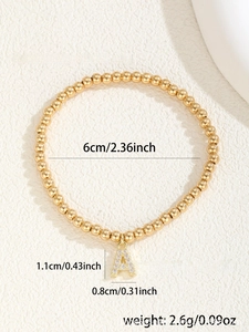 Detail of gold beaded bracelet with crystal paved letter A charm and size dimensions