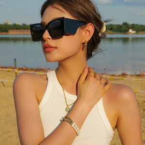 PVD 18K gold plated stainless steel pearl bracelet worn by model on vacation