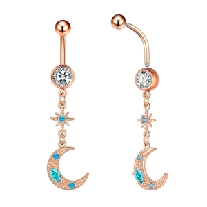 Detail of rose gold belly ring with zircon moon and star charms on white background