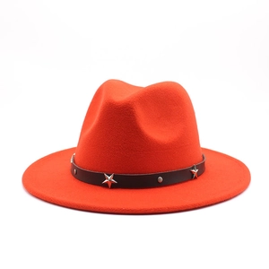 Detail of orange wool fedora featuring a black leather band with silver star rivets