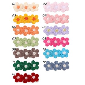 Collection of 13 colorful pastoral style floral embroidered hair clips with numbered labels