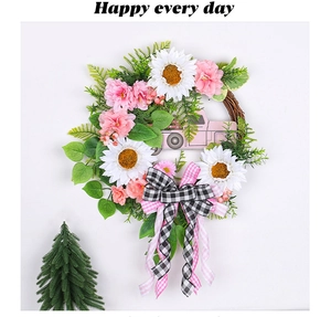 Close-up of pink Christmas wreath with white sunflowers and small truck decor