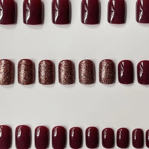 Dark wine red press-on nails set featuring solid glossy and glitter finish designs