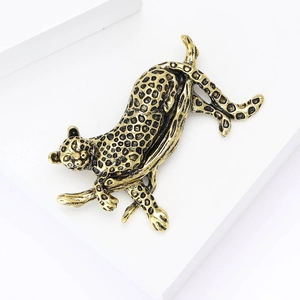 Enamel leopard brooch in antique gold finish climbing dynamic pose on white background