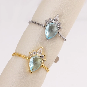 Water drop chain ring with light blue pear-cut gemstone and micro-pave diamonds