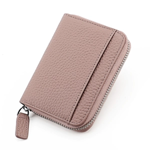 Macro view of dusty rose pebbled leather card holder with zipper and outer slot