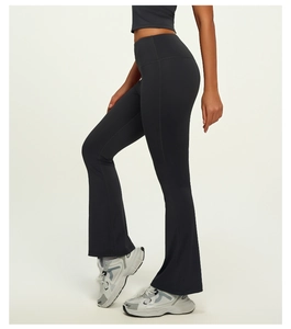 Detail of high-waist flared yoga pants in breathable black stretch fabric with lifting effect