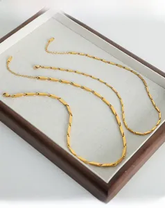 Detailed view of gold-plated titanium steel necklaces with textured geometric links