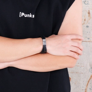 Close-up of black braided leather bracelet with silver magnetic clasp on male wrist