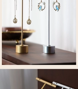 Detail of metal earring display stand featuring precise hanging holes and polished finish