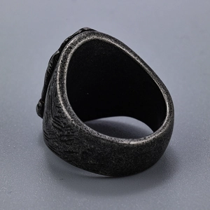 Macro shot of retro stainless steel prayer ring showing thick band and textured surface