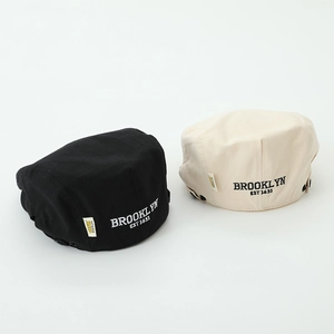 Detail of vintage kid's berets in black and beige with Brooklyn embroidery