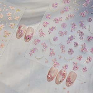 Detail of pink floral nail stickers with gold edges and petal patterns for manicure